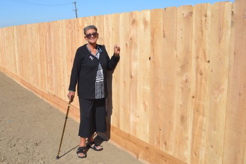 Friends, some old and many new, gather to help Lemoore woman build new fence Lemoore's Connie Ford stands proudly next to her new fence, built the day before by a consortium of Navy volunteers and local residents.